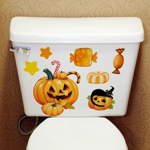 Detail view of Halloween Jack-o'-lantern and black cat wall stickers on a white toilet