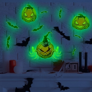 Luminous Halloween wall stickers featuring green glowing pumpkins and bats on a white wall