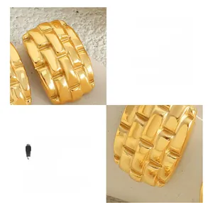 Detailed macro view of 18K gold plated titanium steel earrings with woven texture