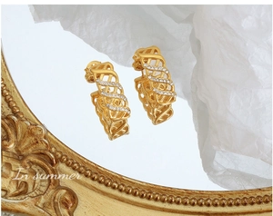 Detailed close-up of vintage gold mesh hoop earrings with sparkling crystal accents