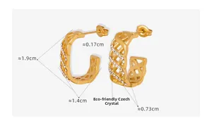 Detail view of gold hollow mesh C-shaped earrings with eco-friendly Czech rhinestones