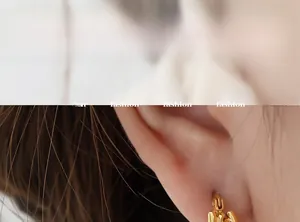 Gros plan de boucles d'oreilles dorées géométriques sur modèle pour un look tendance