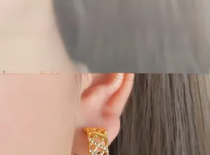Detail of vintage grid lattice gold earrings with sparkling crystals worn by model