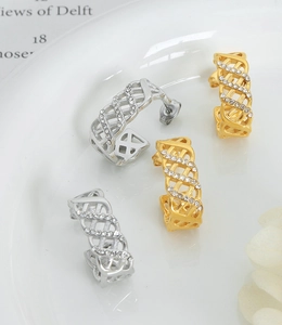 Close-up of gold and silver mesh weave hoop earrings with sparkling cubic zirconia inlay
