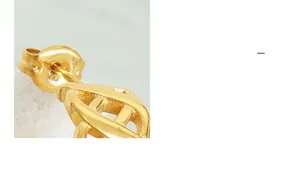 Macro shot of gold-plated butterfly earring back and titanium steel stud hardware detail