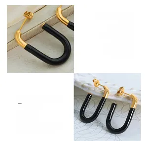 Detail of U-shaped black enamel earrings in 18k gold plated titanium steel hardware