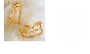 Macro view of gold-plated titanium steel earrings with braided rope and hollow ring textures