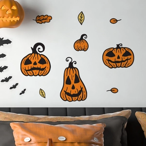 Halloween pumpkin wall decals with bats and leaves displayed over a cozy bedroom headboard