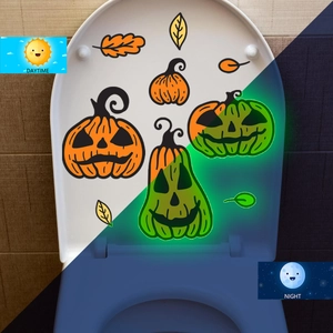 Luminous Halloween pumpkin stickers showing orange daytime and green night glow effect