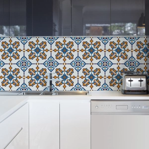 Blue and yellow Mediterranean tile stickers applied as a backsplash in a modern kitchen