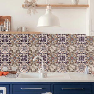 Detail of vintage mandala tile stickers on kitchen backsplash with blue cabinets