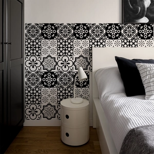Detail of vintage geometric flower tile stickers applied to a minimalist bedroom wall