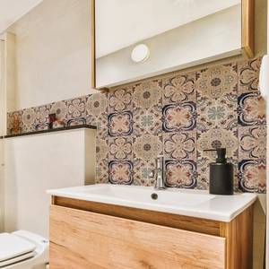Waterproof mandala tile stickers applied to a modern bathroom backsplash background