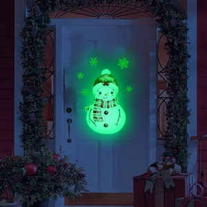 Luminous Christmas snowman and snowflakes wall stickers glowing green on a white door