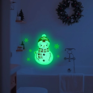 Luminous Christmas snowman wall sticker glowing in a dark room for festive decoration