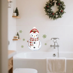 Luminous Christmas snowman and green snowflake wall decals on white bathroom tiles