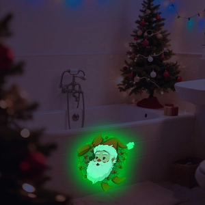 Luminous Christmas Santa wall sticker glowing green in a dark bathroom setting
