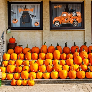 Halloween window decals featuring a vintage orange truck with pumpkins and bats decor
