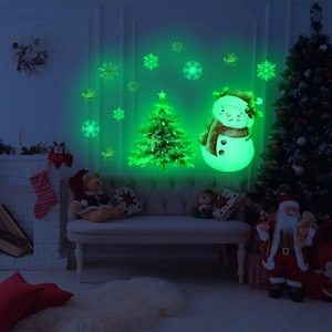 Glow-in-the-dark Christmas wall decals featuring a snowman and snowflakes in a cozy room