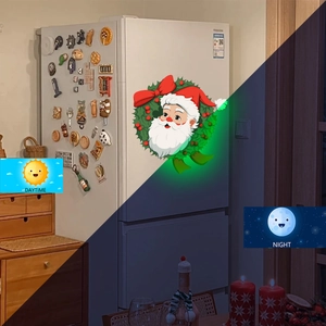 Glow-in-the-dark Santa Claus Christmas wreath wall sticker daytime and night comparison