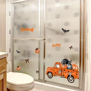 Detail of vintage orange truck with pumpkins and Happy Halloween text window stickers