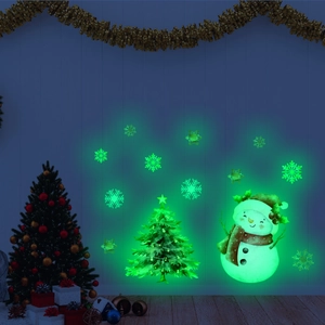Glow-in-the-dark Christmas wall decals featuring a snowman and tree in a dark room