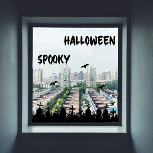 Close-up of black Halloween window silhouettes with bats and spooky graveyard text