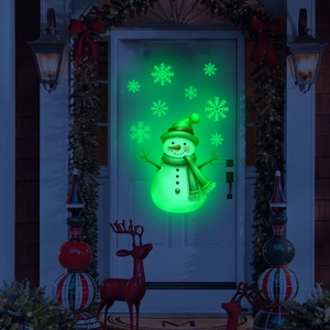 Green glow-in-the-dark Christmas snowman and snowflake wall stickers on a door