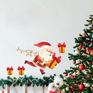 Detailed view of luminous Santa Claus and gift box wall stickers in a cozy festive room