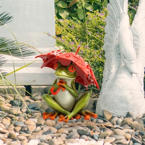 Outdoor garden stake featuring a sitting green frog holding a red umbrella with water drops
