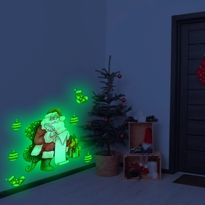 Glow-in-the-dark Christmas Santa and gift box wall stickers showing bright green fluorescence