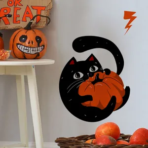 Detail of Halloween window sticker showing a cute black cat hugging a large orange pumpkin