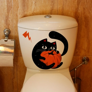 Halloween black cat and pumpkin sticker applied on a white bathroom toilet tank