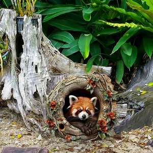 Garden decoration featuring a detailed red panda figurine peeking from a hollow tree stump