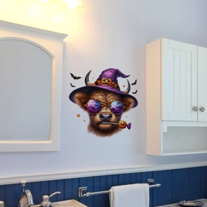 Detail of Halloween highland cow wall sticker with wizard hat on a clean bathroom wall