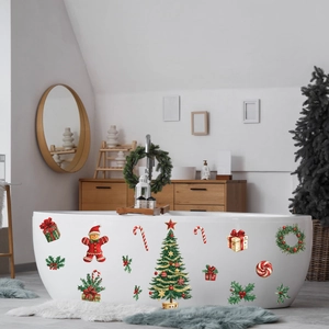 Christmas tree and gingerbread man decals applied on a smooth white bathtub surface