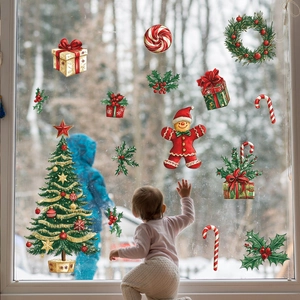 Detail of Christmas window stickers with tree and gingerbread man in festive home setting