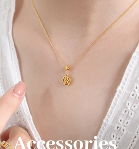 Close-up of golden stainless steel necklace with hollow Double Happiness round pendant