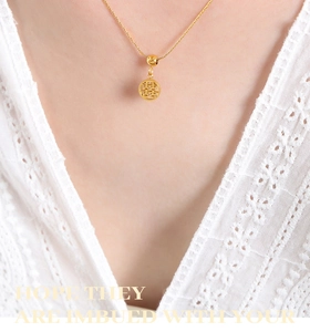 Detail shot of a gold-plated titanium steel necklace with a hollow double happiness pendant