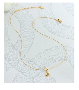 Detailed macro view of the double happiness gold-plated titanium steel necklace