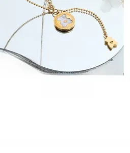 Macro view of gold teddy bear pendant with white mother of pearl inlay on mirror surface