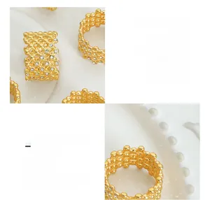Macro detail of gold plated honeycomb ring featuring hollow grid and inlaid cubic zirconia