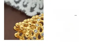 Macro detail of vintage mesh ring with sparkling crystals in a warm gold finish