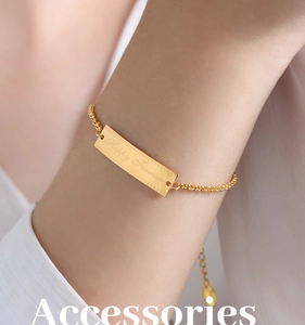 Detailed close-up of gold plated stainless steel bracelet with Happy Forever engraving