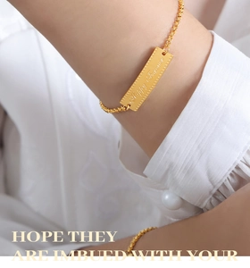 Detail of 18k gold plated curved square charm bracelet with Happy Forever engraving