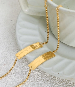 Detail of gold titanium steel bracelet with Happy Forever engraved lace square pendant