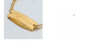 Macro detail of gold plated curved square plaque with Happy Everyday engraving