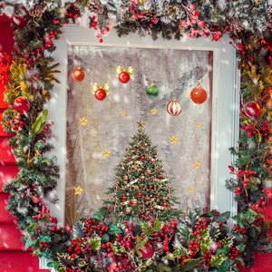 Detailed view of Christmas tree and colorful baubles window stickers on a snowy glass pane