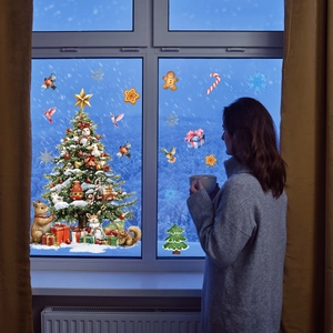 Cozy scene showing a large Christmas tree window sticker and festive holiday decorations