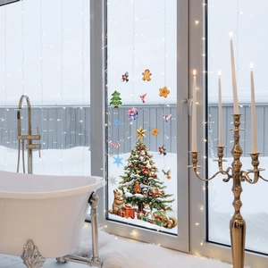 Detailed Christmas window stickers with hand-painted trees and squirrels on snowy glass